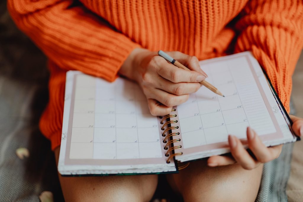 Planner open in a young woman's hands